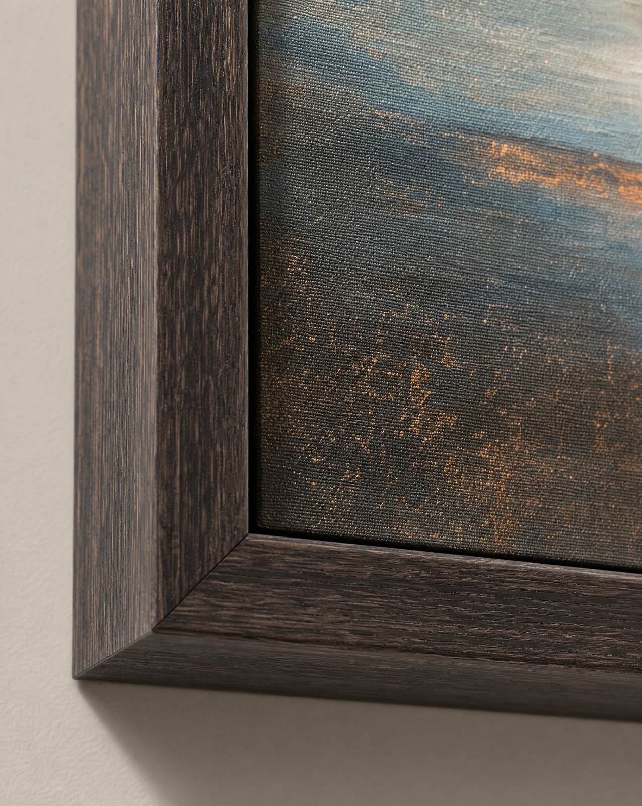Close-up of a dark stained wood frame corner meeting gallery-wrapped canvas