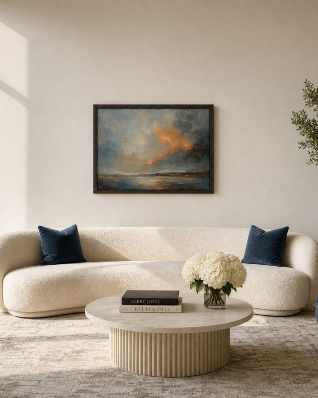 Living room design visualisation with ivory curved sofa, navy chair, and artwork sized to the sofa, Dubai skyline beyond.