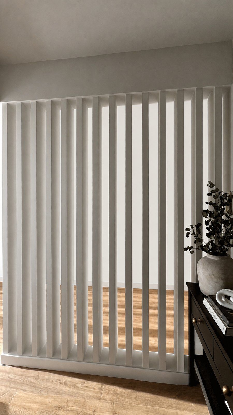 The finished slatted timber room divider beside a styled console with a stone vase and eucalyptus, Studio Sakaia, Dubai