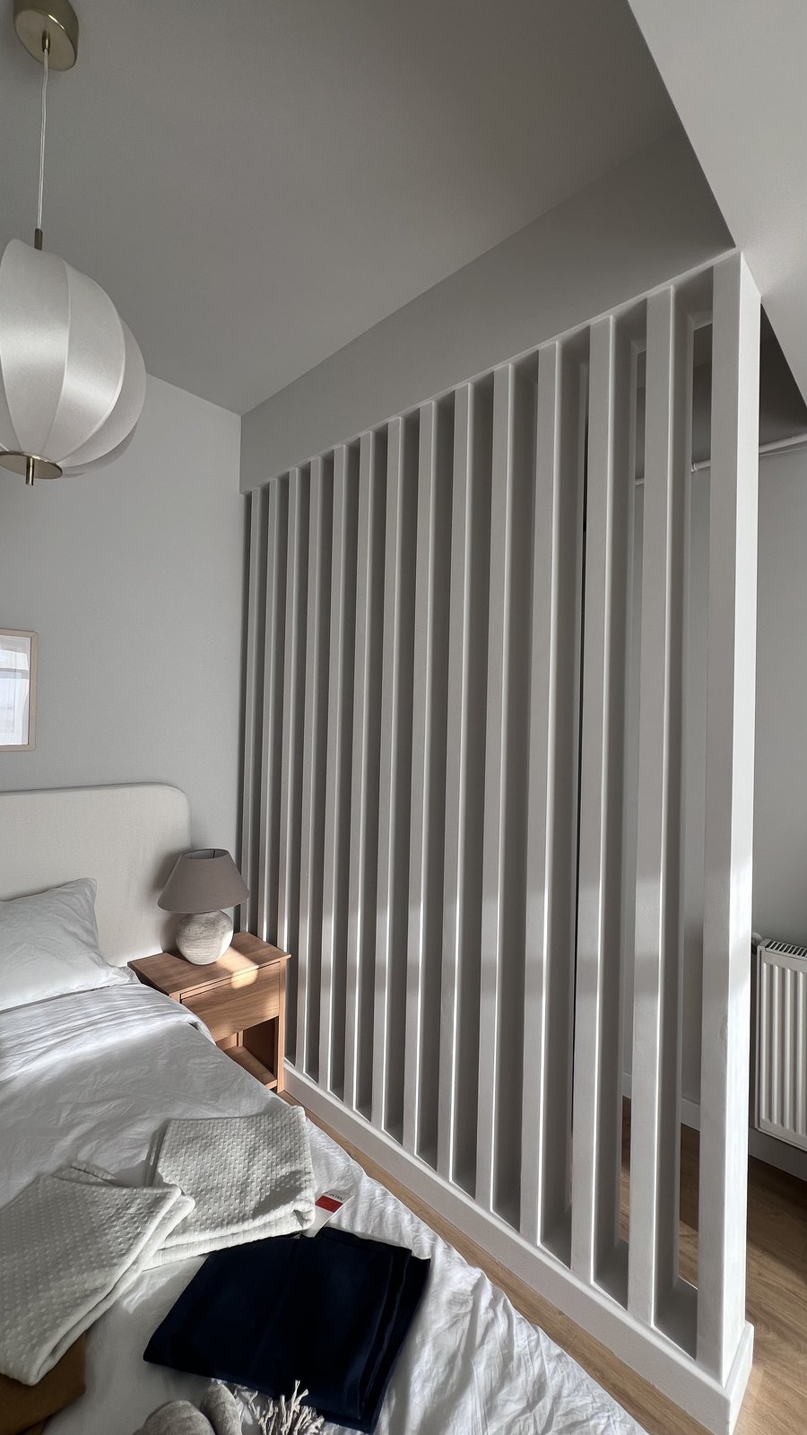 The finished slatted room divider seen from the styled bedroom side, Studio Sakaia, Dubai