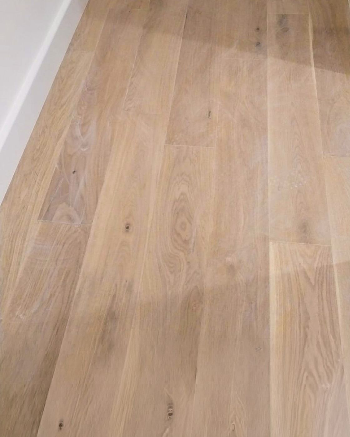 A close detail of wide engineered oak planks in warm light, Studio Sakaia, Dubai