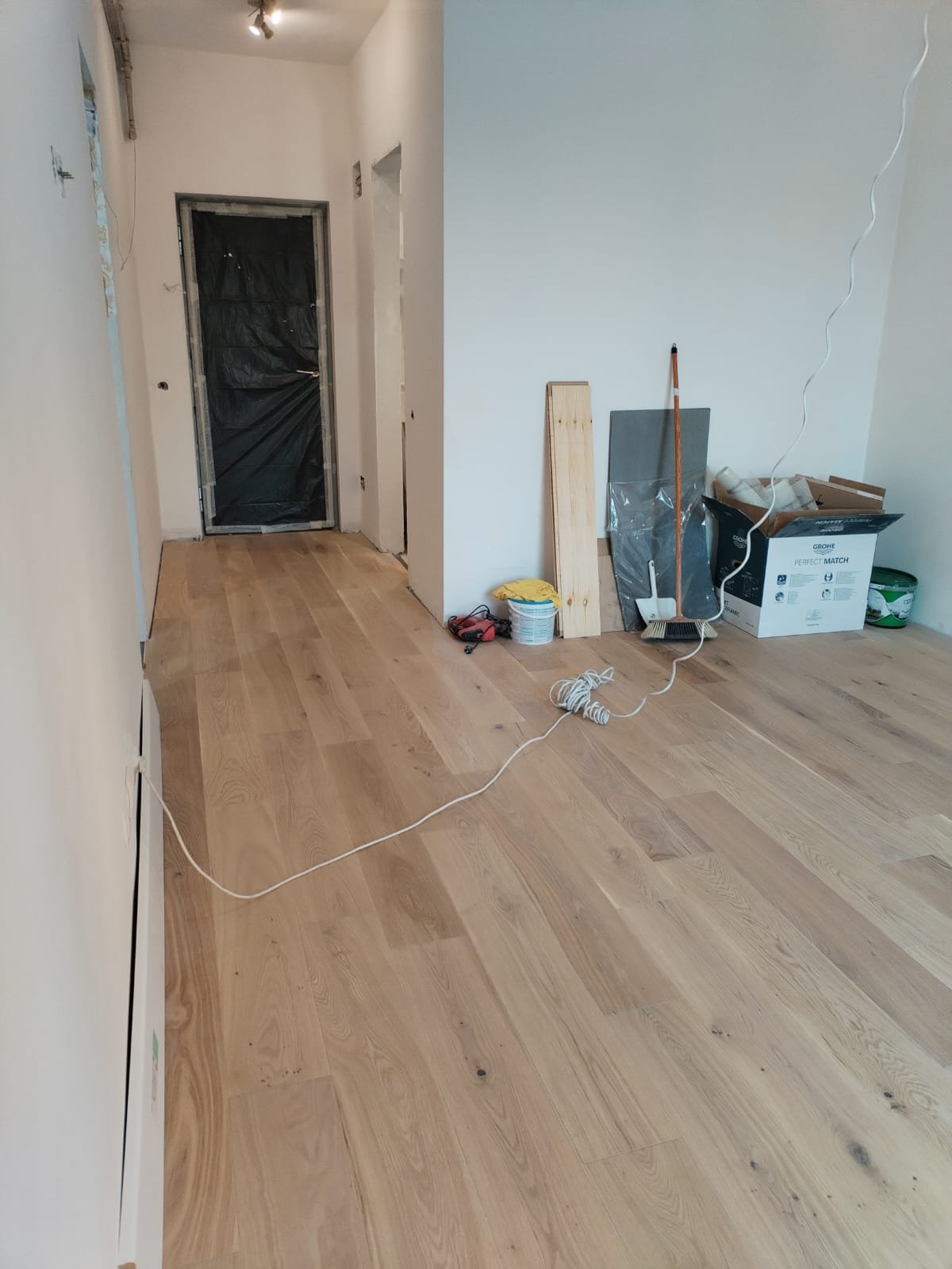 Engineered oak boards going down over underlay during the October install, Studio Sakaia, Dubai