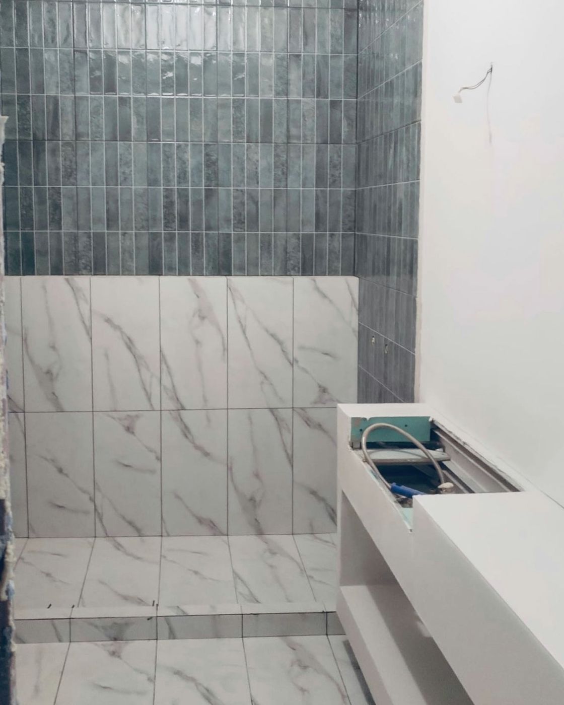Fluted teal tile and marble finished up the walls with the vanity niche framed in beside it, Studio Sakaia, Dubai