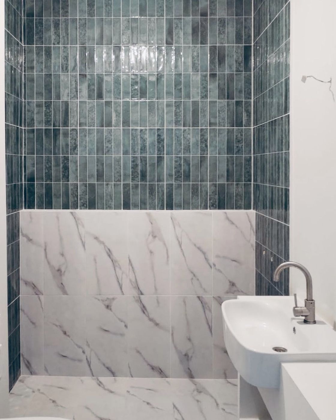 The finished shower in fluted teal tile and marble with the basin mounted, near complete, Studio Sakaia, Dubai