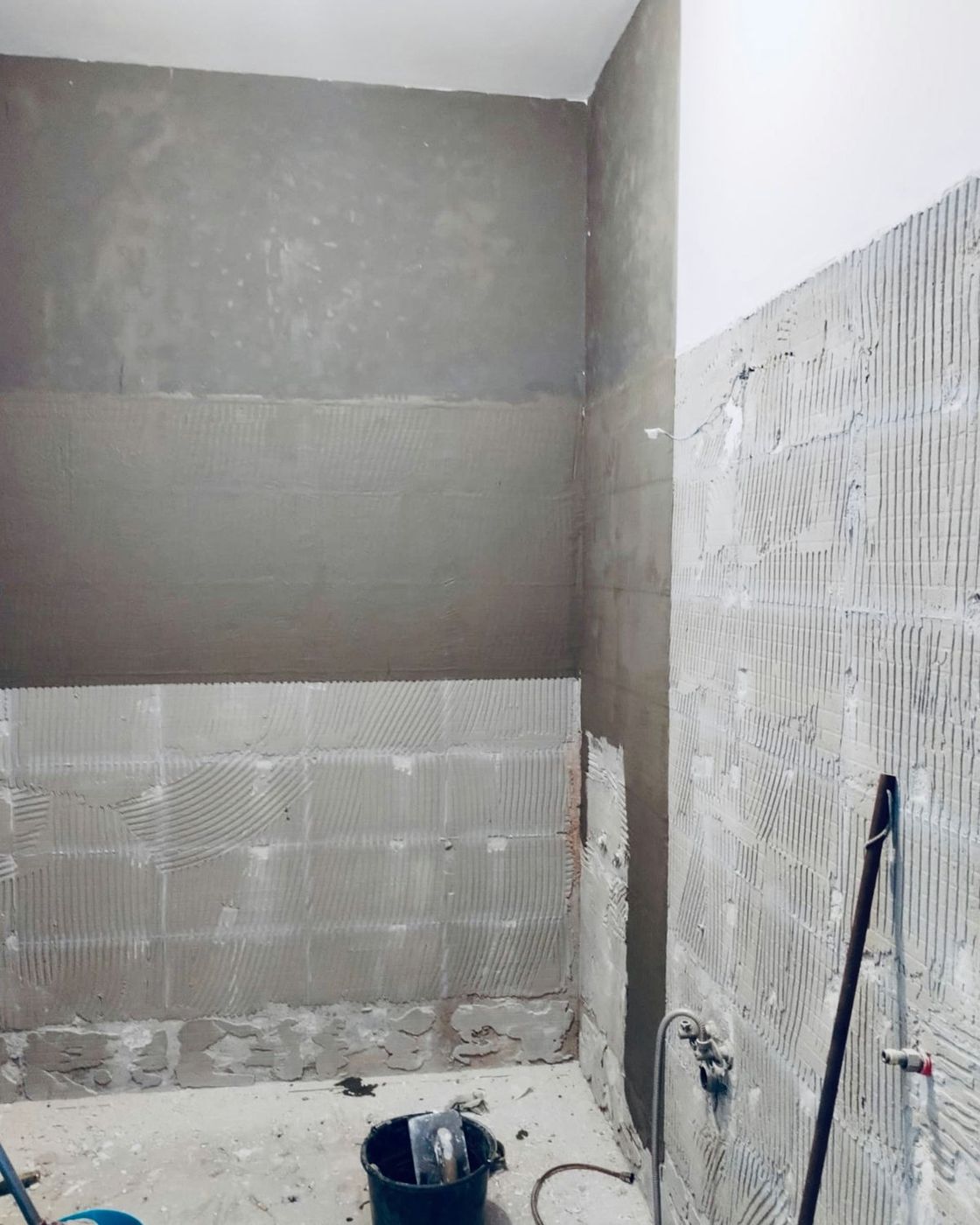 Walls stripped back to render with waterproofing membrane going on in the corner, early in the works, Studio Sakaia, Dubai