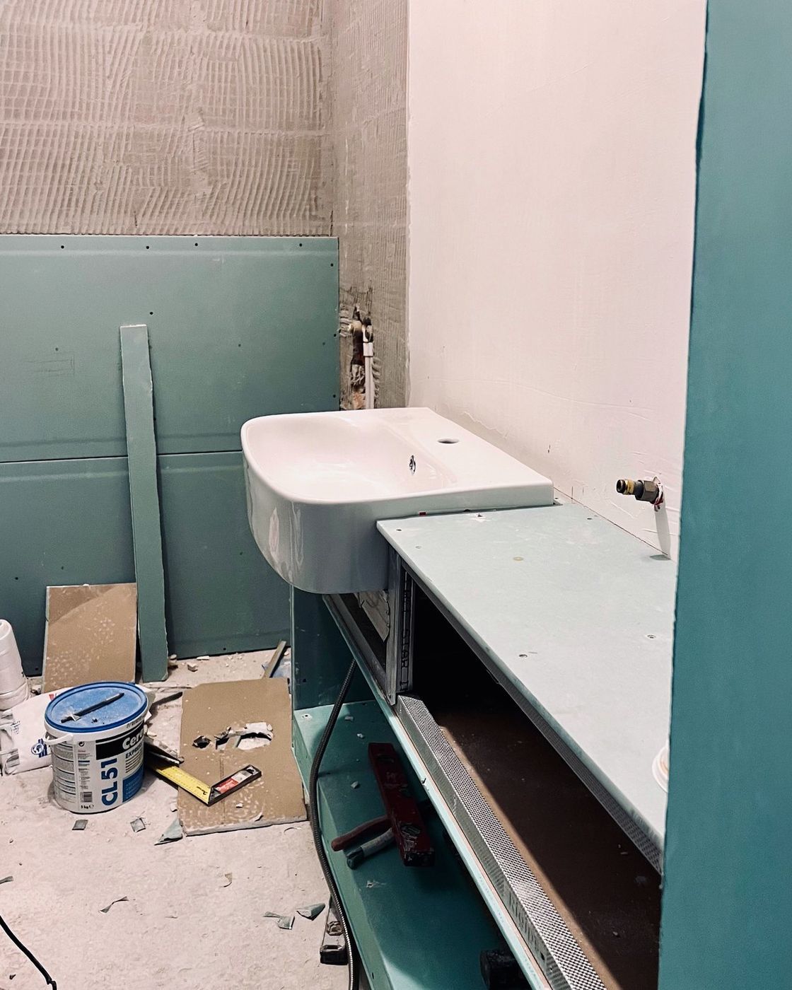 The basin rough-set on moisture resistant board with the vanity carcass framed in beside it, Studio Sakaia, Dubai