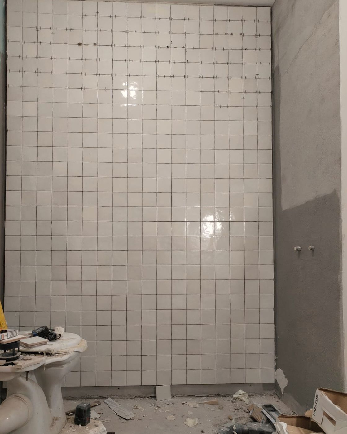 Zellige-look tile going up on a shower wall, tiling underway, Studio Sakaia, Dubai