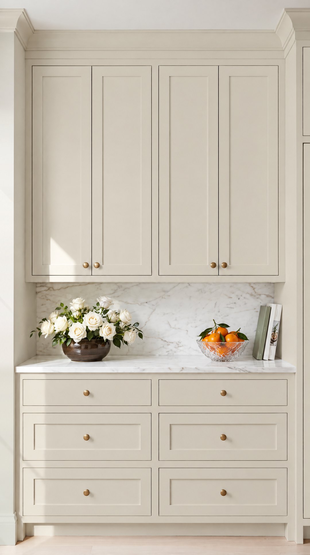 Shaker kitchen cabinets painted in warm greige Baby Fawn with brass knobs, design visualisation by Studio Sakaia.