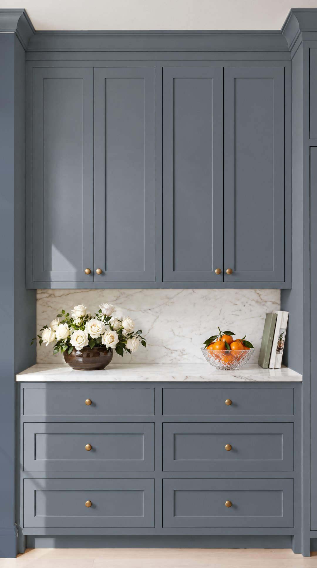 Deep blue grey Grays Harbor Shaker kitchen cabinets with brass knobs and Carrara marble, design visualisation by Studio Sakaia.