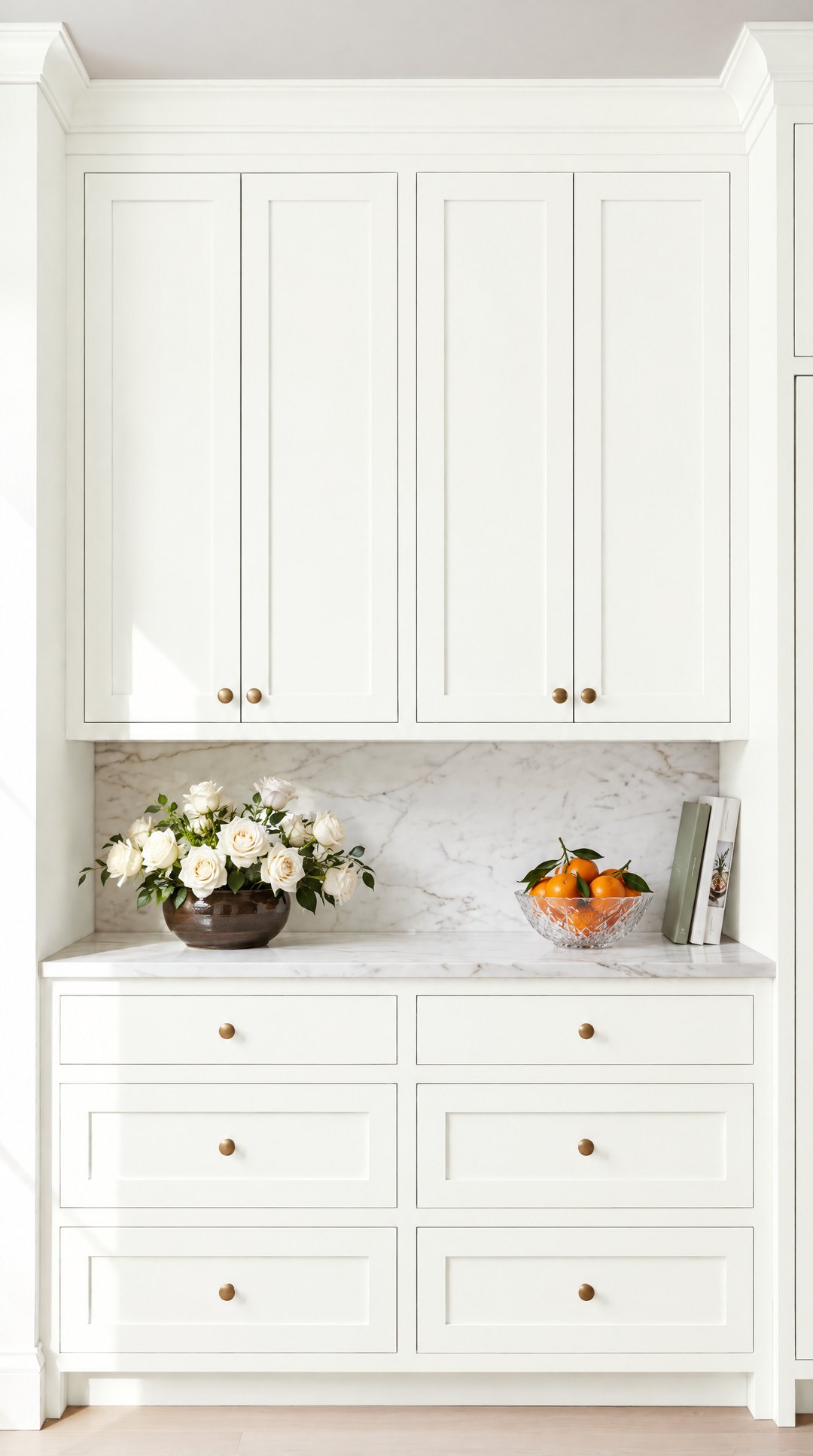 Shaker kitchen cabinets painted in bright Simply White with brass knobs and Carrara marble, design visualisation by Studio Sakaia.
