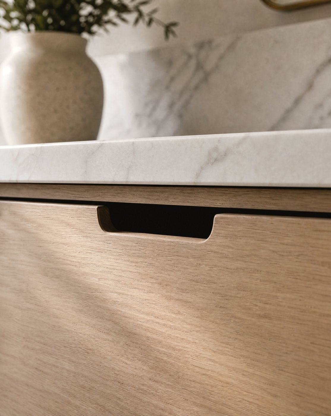Joinery detail design study: routed cutout pull in a white oak drawer front under a marble edge.