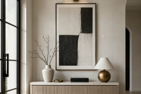 A large framed artwork made to the exact proportions of a Dubai living room wall, hung at eye level above a low console, warm daylight, Studio Sakaia, Dubai