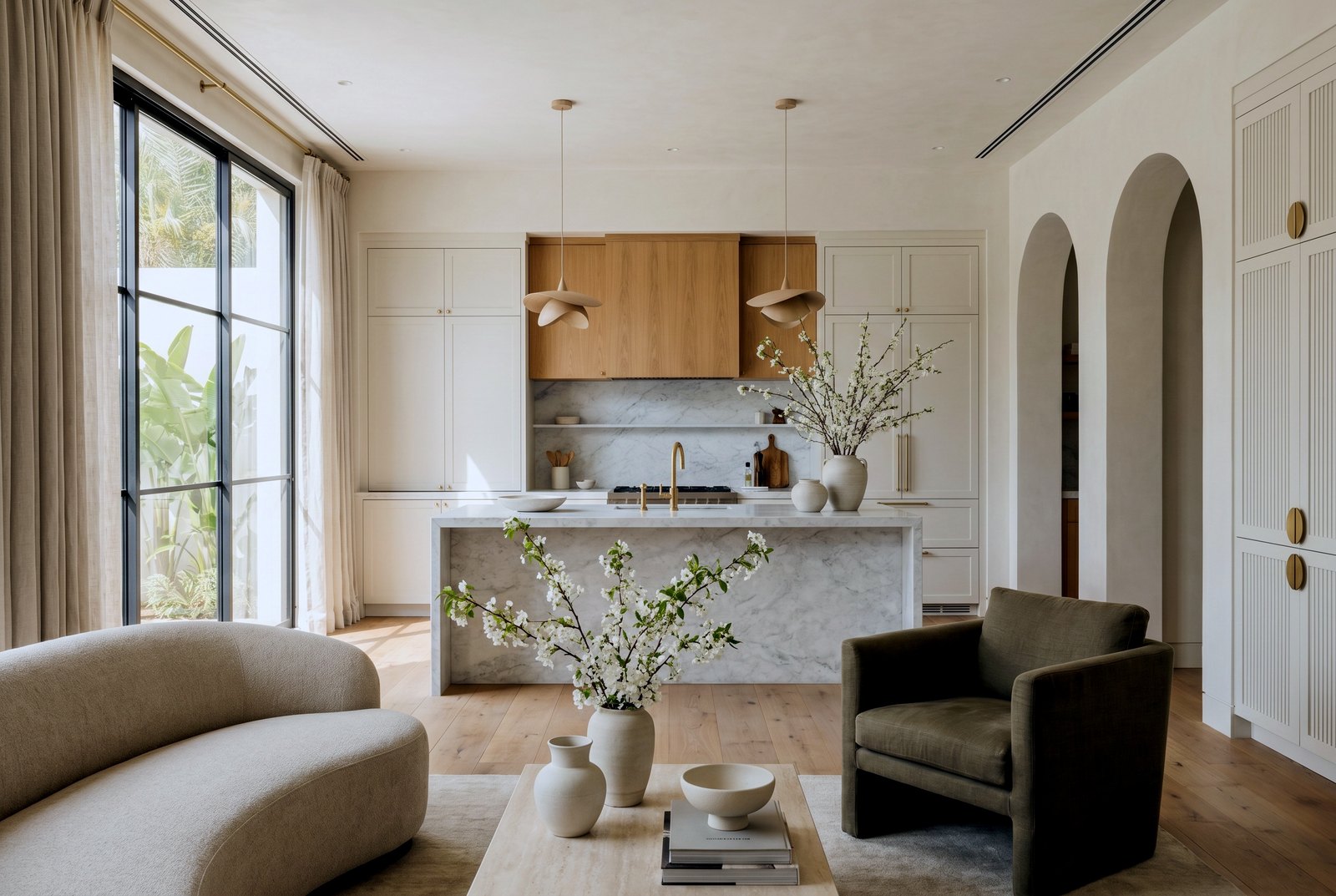 Warm modern kitchen with a marble waterfall island and oak cabinetry, Palm Jumeirah villa renovation, Dubai