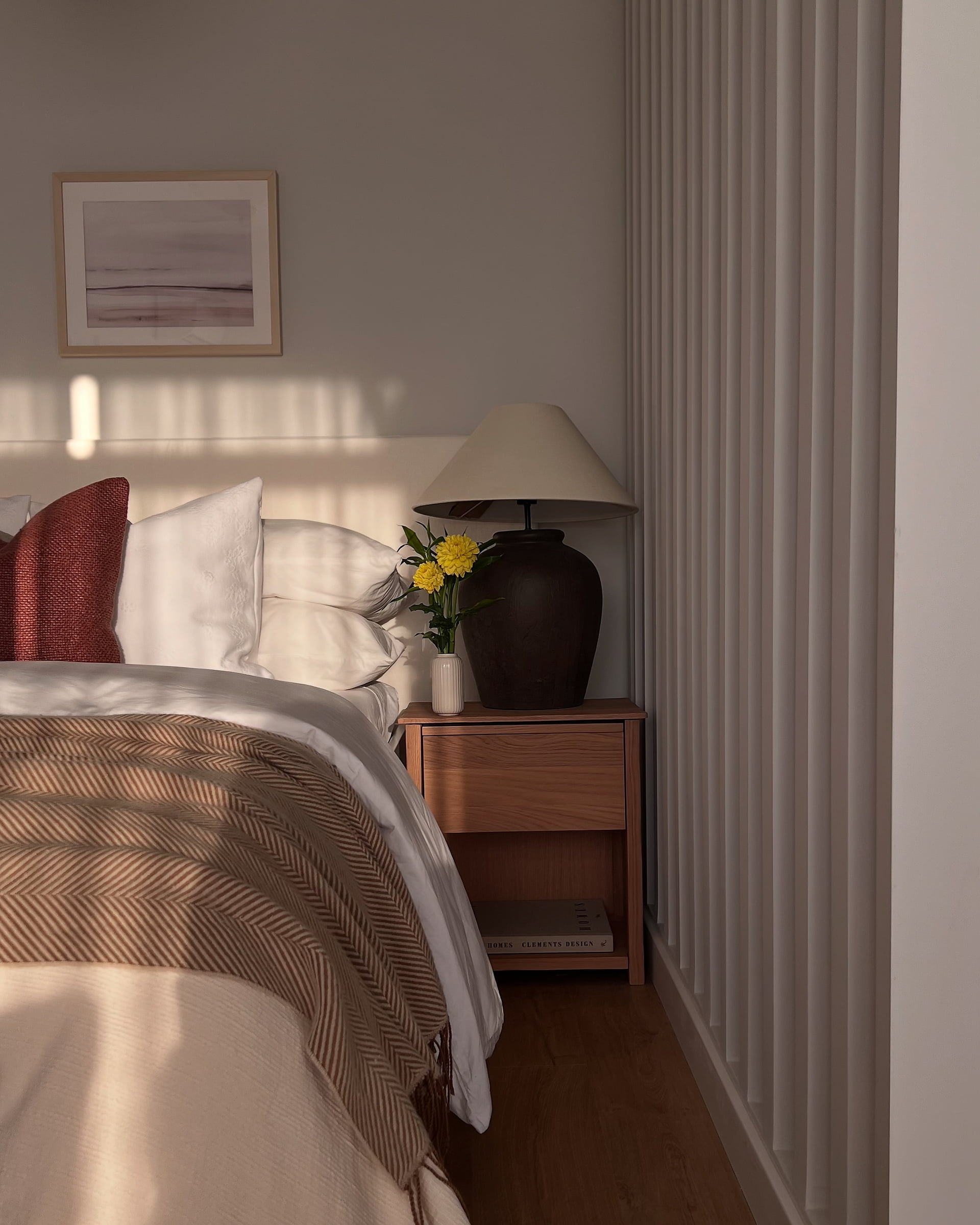 Studio 51 bedroom at golden hour: layered linen, a herringbone throw and a ceramic lamp, Business Bay, Dubai