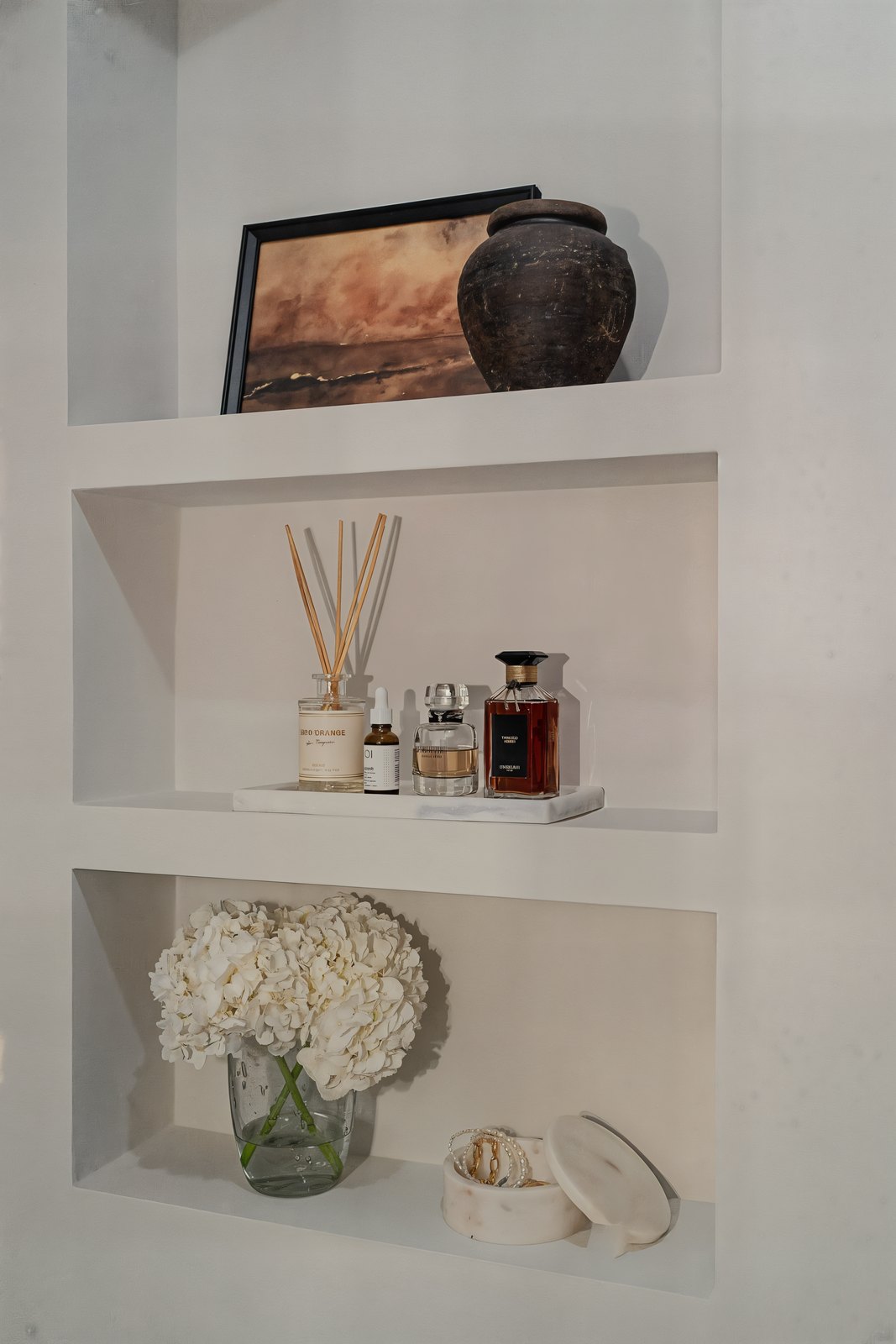 Styled plaster niches in Studio 51 with a diffuser, scent and dried hydrangea, Business Bay, Dubai